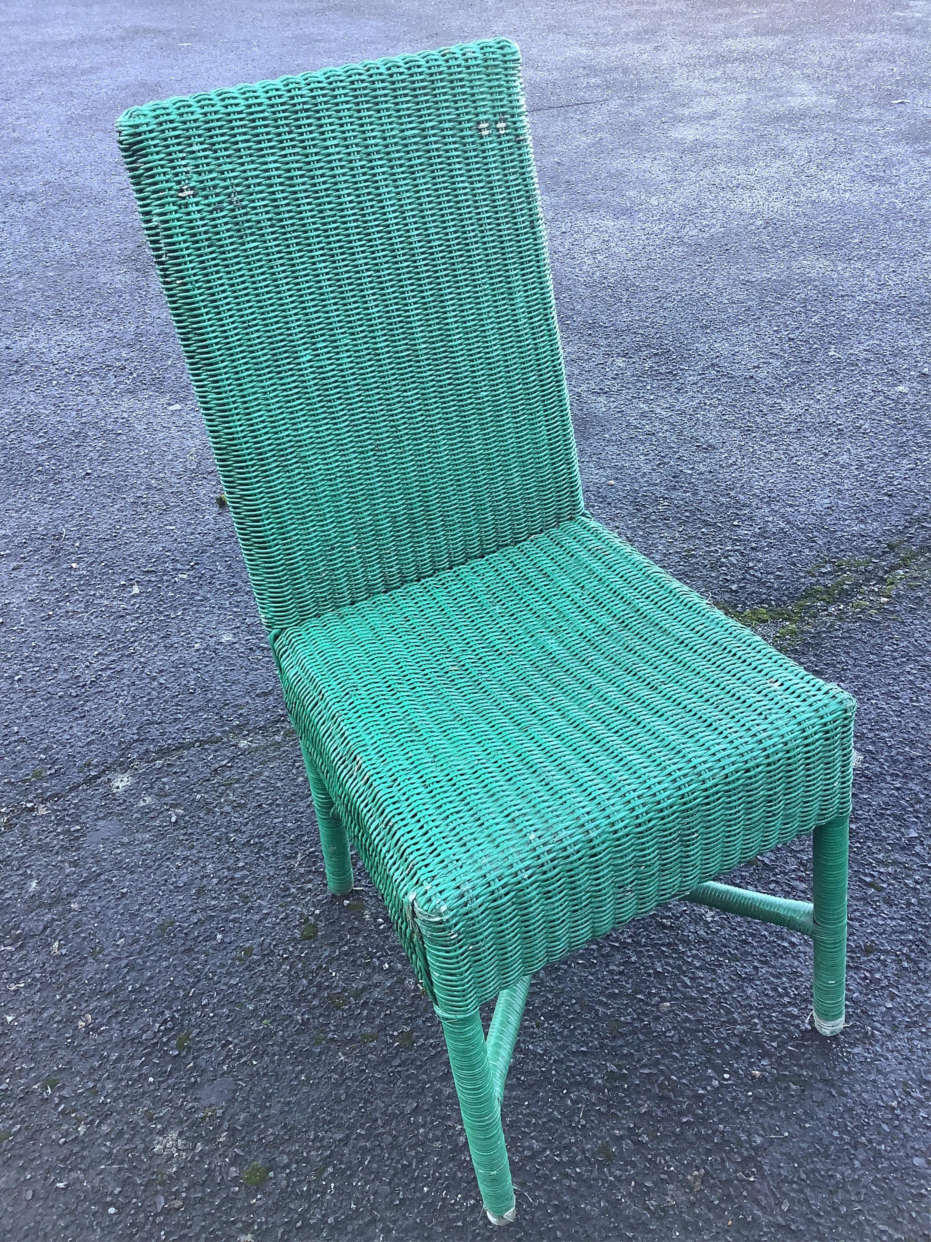 A weathered teak garden table, width 180cm, depth 99cm, height 75cm and eleven Habitat wicker chairs. Condition - poor